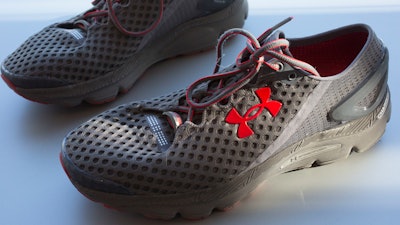 In this Monday, Jan. 4, 2016, file photo, a pair of Under Armour SpeedForm Gemini 2 Record Equipped running shoes, containing an embedded chip to track exercise, are displayed in New York. Under Armour Inc. reports earnings Tuesday, Oct. 31, 2017.