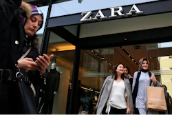 People exit and walk past a fashion retailer Zara branch in an Istanbul upscale neighbourhood, Friday, Nov. 3, 2017. Shoppers at Zara in Istanbul have found unusual tags on their garments: put there by Turkish workers complaining they have not been paid for the manufacturing the merchandise in the store. Workers of an outsource manufacturer have been leaving tags inside clothes saying: 'I made this item you are going to buy, but I didn't get paid for it.'