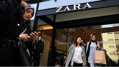 People exit and walk past a fashion retailer Zara branch in an Istanbul upscale neighbourhood, Friday, Nov. 3, 2017. Shoppers at Zara in Istanbul have found unusual tags on their garments: put there by Turkish workers complaining they have not been paid for the manufacturing the merchandise in the store. Workers of an outsource manufacturer have been leaving tags inside clothes saying: 'I made this item you are going to buy, but I didn't get paid for it.'