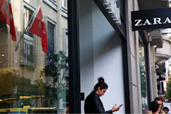 In this Friday, Nov. 3, 2017 file photo, a shopper exits a branch of fashion retailer Zara in an upscale Istanbul neighbourhood. Zara said Monday, Nov. 6, 2017, it is working on establishing a 'hardship fund' to help a group of Turkish workers who were left unpaid when an outsource factory closed down. The workers went into Zara shops in Istanbul, leaving tags inside garments that read: 'I made this item you are going to buy, but I didn't get paid for it.'