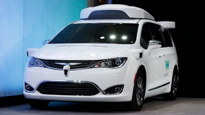 In this Sunday, Jan. 8, 2017, file photo, a Chrysler Pacifica hybrid outfitted with Waymo's suite of sensors and radar is shown at the North American International Auto Show in Detroit. Waymo is testing vehicles on public roads with only an employee in the back seat. The testing started Oct. 19 with an automated Chrysler Pacifica minivan in the Phoenix suburb of Chandler, Ariz. It’s a major step toward vehicles driving themselves without human backups on public roads.