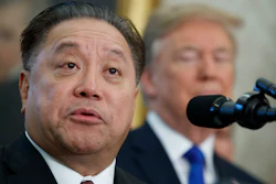 In this Thursday, Nov. 2, 2017, file photo, Broadcom CEO Hock Tan speaks as President Donald Trump listens during an event to announce the company is moving its global headquarters to the United States, in the Oval Office of the White House, in Washington. Broadcom is making an unsolicited, $130 billion offer for rival chipmaker Qualcomm.