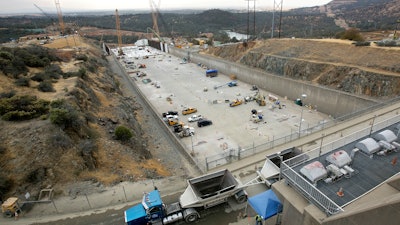 In this Oct. 19, 2017 file photo, work continues to repair the damaged main spillway of the Oroville Dam in Oroville, Calif. California is launching an overall safety review of the nation's tallest dam to pinpoint any needed upgrades or repairs in the half-century-old dam, water officials said Wednesday, Nov. 1, 2017. An independent national panel of dam-safety experts had called for that kind of overarching review at Oroville Dam in September following last winter's collapse of the dam's two spillways.