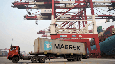 In this Nov. 8, 2017, photo, a truck moves a Maersk shipping container at a port in Qingdao in eastern China's Shandong Province. Chinese manufacturing activity improved in November, a survey showed Thursday, Nov. 30, 2017, adding to signs of a pickup in global and domestic demand.