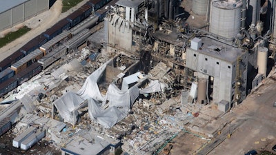 In this June 1, 2017 file photo, part of the Didion Milling Plant lies in ruins following a May 31, 2017, explosion in Cambria, Wis. Federal labor officials say the Wisconsin milling company should pay $1.8 million in fines for failing to prevent the fatal explosion. The Occupational Safety and Health Administration issued a news release Friday, Nov. 17, saying that an accumulation of highly combustible grain dust likely caused the explosion. OSHA officials said the explosion was preventable.