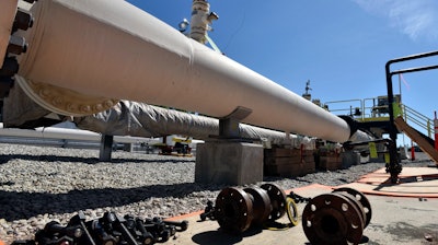 In this June 8, 2017 file photo, fresh nuts, bolts and fittings are ready to be added to the east leg of the pipeline near St. Ignace, Mich., as Canadian oil transport company Enbridge prepares to test the east and west sides of the Line 5 pipeline under the Straits of Mackinac. Michigan Gov. Rick Snyder and Enbridge Inc. have reached an agreement they say will boost the safety of twin pipelines beneath the waterway where Lakes Huron and Michigan converge. The deal announced Monday, Nov. 27, includes a requirement that Line 5 be shut down temporarily during storms that cause high waves in the straights for an hour or longer.