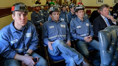 Coal miners listen to speakers during an Environmental Protection Agency public hearing, Tuesday, Nov. 28, 2017, at the state Capitol in Charleston, W.Va. The EPA was taking comments Tuesday and Wednesday on its proposed repeal of the Clean Power Plan, an Obama-era plan to limit planet-warming carbon emissions.
