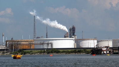 This Friday, Oct. 13, 2017, photo taken from upper Galveston Bay shows the Exxon Mobil Baytown refinery and chemical plant in Baytown, Texas. On Tuesday, Oct. 31, 2017, federal officials said that Exxon Mobil settled violations of the clean-air law with the Trump administration by agreeing to pay a $2.5 million civil penalty and spend $300 million on pollution-control technology at plants along the Gulf Coast. The plants are in Baytown, Beaumont and Mont Belvieu, Texas, and Baton Rouge, Louisiana. As part of the settlement, Exxon will spend $1 million to plant trees in Baytown.