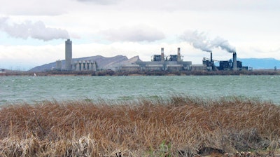 This April, 2006 file photo shows the Four Corners Power Plant in Waterflow, N.M., near the San Juan River in northwestern New Mexico. Unions that represent Navajo workers say contractors at a northwestern New Mexico power plant are violating tribal labor laws. The tribe enacted the Navajo Preference in Employment Act in 1985, requiring the hiring of qualified Navajos over other applicants, to keep Navajos working on the reservation where jobs are scarce.