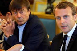 In this Sept.5 2017 file photo, French President Emmanuel Macron, right, and Environment Minister Nicolas Hulot meet with NGOs to discuss climate and environment at the Elysee Palace in Paris. Macron is planning a climate summit next month to push his 'Make our Planet Great Again' agenda, and to unveil the winners of his fellowship competition for U.S. climate scientists frustrated by the Trump administration's attitude toward global warming.