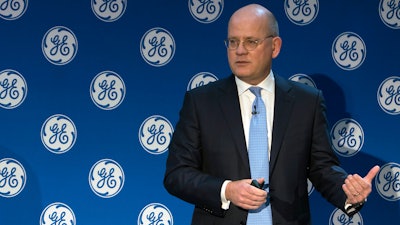 In this Monday, Nov. 13, 2017, photo provided by General Electric, GE Chairman and CEO John Flannery addresses investors at a meeting in New York. Flannery said the company is weighing the future of its transportation, industrial, and lighting businesses so that it can focus more intently on its most profitable divisions.
