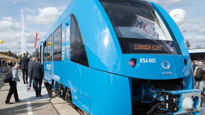 In this Sept 20, 2016 file photo visitors look at an Alstom hydrogen-powered train at the InnoTrans international trade fair for transport technology in Berlin. Rail passengers in northern Germany will be able to travel on the world’s first hydrogen-powered trains in four years’ time. French engineering giant Alstom says it has signed an agreement to deliver 14 fuel cell trains to LNVG, a rail company in Germany’s Lower Saxony state.