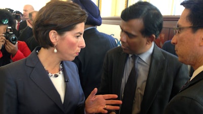 Rhode Island Gov. Gina Raimondo, left, and Infosys President Ravi Kumar, center, speak after a news conference, Monday, Nov. 27, 2017, in Providence, R.I., announcing the India-based information technology outsourcing firm will open a design and innovation hub in the state and plans to add 500 jobs there in the next five years.