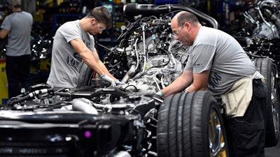 In this Friday, Oct. 27, 2017, photo, workers assemble Ford trucks at the Ford Kentucky Truck Plant in Louisville, Ky. On Thursday, Nov. 16, 2017, the Federal Reserve reports on U.S. industrial production for October.