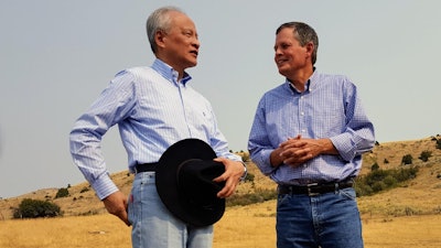In this Sept. 8, 2017 photo, Chinese ambassador to the United States Cui Tiankai, left, speaks with Republican Montana Sen. Steve Daines about ways to expand the Chinese market for Montana beef. The two met with other Chinese and Montana agriculture officials during a tour of a ranch in the Bozeman area. China's largest online retailer has signed a deal with the Montana Stockgrowers Association to buy $200 million worth of Montana beef over the next three years and to build a $100 million slaughterhouse in the state.
