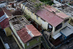 In this Nov. 15, 2017 photo, some roofs damaged by the whip of Hurricane Maria are still exposed to rainy weather conditions, in San Juan, Puerto Rico. A newly created Florida company with an unproven record won more than $30 million in contracts from the Federal Emergency Management Agency to provide emergency tarps and plastic sheeting for repairs to hurricane victims in Puerto Rico. Bronze Star LLC never delivered those urgently needed supplies, which even months later remain in demand on the island.