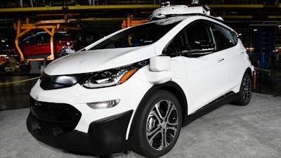 In this Tuesday, June 13, 2017, file photo, a self-driving Chevrolet Bolt EV that is in General Motors Co.'s autonomous vehicle development program appears on display at GM's Orion Assembly in Lake Orion, Mich. California regulators are embracing a General Motors recommendation that would help makers of self-driving cars avoid paying for accidents and other trouble, raising concerns that the proposal will put an unfair burden on vehicle owners.
