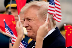 Children wave U.S. and Chinese flags as President Donald Trump arrives at Beijing Airport, Wednesday, Nov. 8, 2017, in Beijing, China. Trump is on a five country trip through Asia traveling to Japan, South Korea, China, Vietnam and the Philippines.