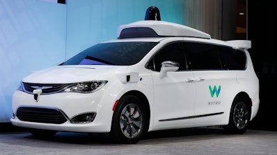 In this Sunday, Jan. 8, 2017, file photo, a Chrysler Pacifica hybrid outfitted with Waymo's suite of sensors and radar is displayed at the North American International Auto Show in Detroit. Google is partnering with AutoNation, the country's largest auto dealership chain, in its push to build a self-driving car. AutoNation said Thursday, Nov. 2, that its dealerships will provide maintenance and repairs for Waymo's self-driving fleet of Chrysler Pacifica vehicles.