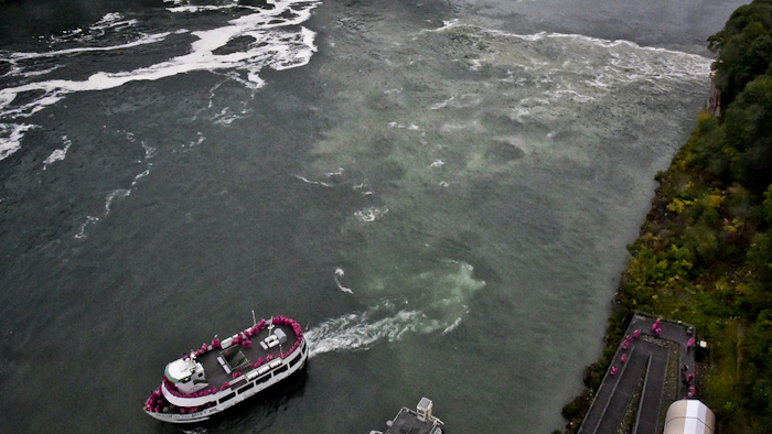 In this Oct. 9, 2017 file photo, a tour boat travels along the Niagara River in New York, where a series of overflow discharge from a treatment plant have drawn widespread attention. The sewage treatment plant that spewed a smelly black discharge at the base of Niagara Falls during the busy summer tourist season is in line for $20 million in upgrades. Gov. Andrew Cuomo proposed the state investment Tuesday, Dec. 19 as one of his 2018 priorities.