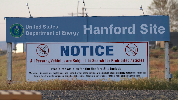 In this May 9, 2017, file photo, signs are posted by the Hanford Nuclear Reservation in Richland, Wash. By conducting some of the most high-tech research in the world, maintaining the U.S. stockpile of nuclear weapons and cleaning up after decades of bomb-making, the Department of Energy has its share of management challenges. A report released this week outlines some of those challenges while providing a look at the expansive scope of the department's responsibilities and costly liabilities.
