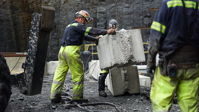 In this Wednesday, June 7, 2017, file photo, a worker lowers a concrete block at the site of a new coal mine in Friedens, Pa. On Friday, Dec. 15, 2017, the Federal Reserve said mining activity climbed 2 percent in November, while manufacturing activity rose 0.2 percent.