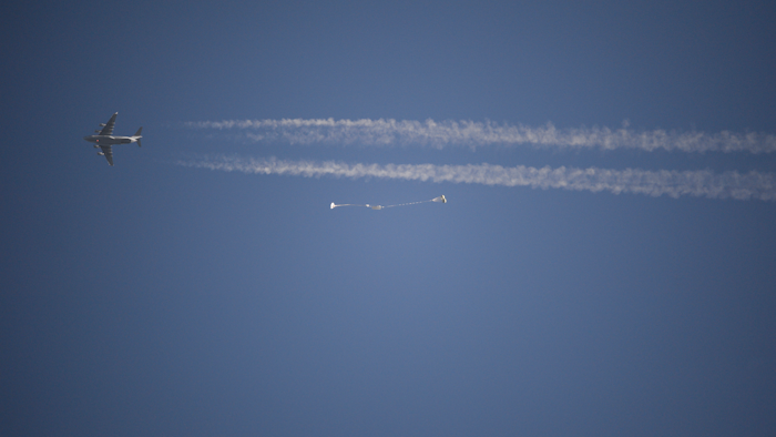 In this photo released by NASA, a replica Orion Spacecraft is dropped from a U.S. Air Force C-17 transport aircraft at 35,000 feet in altitude to a southwestern Arizona desert site to test the craft's ability to cope with a partial parachute failure at the U.S. Army Proving Ground in Yuma, Ariz., Friday, Dec. 15, 2017. The test used two of Orion's three main parachutes to simulate the failure of the third and still sufficiently slowed the spacecraft for a landing. It was the fifth of eight tests to qualify Orion's parachute system for flights with astronauts beginning with Exploration Mission-2.