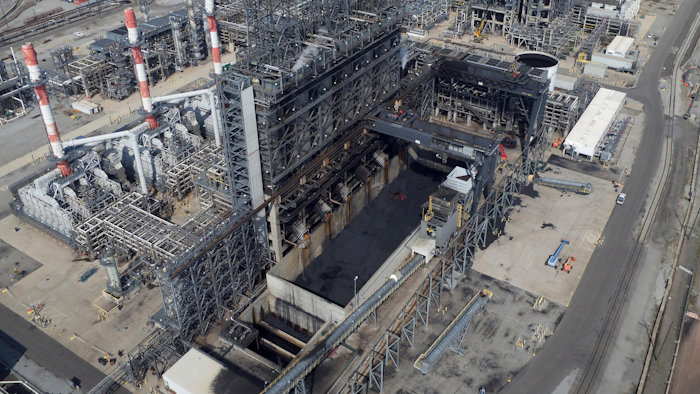 In this Sept. 21, 2017 photo, petroleum coke, the grainy black byproduct of refining Canadian tar sands oil, is visible at the BP Whiting refinery in East Chicago, Ind. The U.S. is the world's largest producer and exporter of 'petcoke,' with the largest share being shipped to India in recent years. The high-carbon, high-sulfur fuel is dirtier than coal, and has been burned unregulated in Indian factories and power plants, contributing to that nation's already-high air pollution levels.