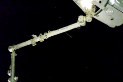 In this image taken from NASA Television, the robotic arm reaches out and captures the SpaceX Dragon cargo spacecraft for docking to the International Space Station.