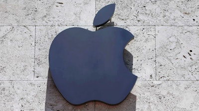 This Tuesday, Aug. 8, 2017, file photo shows the Apple logo at a store in Miami Beach, Fla. Apple is investing $390 million in Finisar, a company that makes the lasers used in facial recognition. The investment announced Wednesday, Dec. 13, is the latest from Apple’s $1 billion Advanced Manufacturing Fund, dedicated to investments in U.S. manufacturers and creating jobs in the U.S.