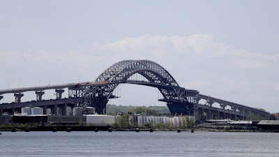 This May 2, 2017, file photo shows the Bayonne Bridge prior to a news conference announcing the bridge project completion, seen from Elizabeth, N.J. The elevation of the Bayonne Bridge was projected to cost about $1.3 billion before construction began more than four years ago. This week, the Port Authority of New York and New Jersey, which owns and operates the bridge, approved allocating between $350 million and $400 million more, an overrun of more than 25 percent.