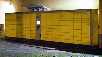 The DHL pack station is pictured at the corner of Kantstrasse and Roseggerstrasse, form where the parcel bomb was sent, in Potsdam, eastern Germany, Sunday, Dec. 3, 2017. German authorities said the suspicious package containing nails that led to a bomb scare on a Christmas market in Potsdam was part of a blackmailing plot against the delivery company. Brandenburg state Interior Minister Karl-Heinz Schroeter told reporters the package was part of a scheme to extort millions of euros from delivery company DHL.