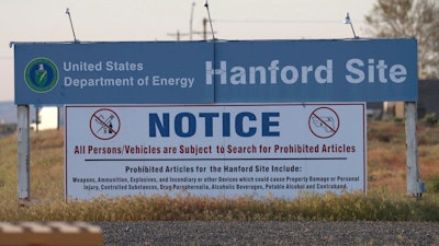 In this May 9, 2017, file photo, signs are posted by the Hanford Nuclear Reservation in Richland, Wash. By conducting some of the most high-tech research in the world, maintaining the U.S. stockpile of nuclear weapons and cleaning up after decades of bomb-making, the Department of Energy has its share of management challenges. A report released this week outlines some of those challenges while providing a look at the expansive scope of the department's responsibilities and costly liabilities.