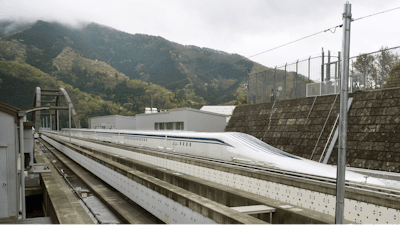 In this April 21, 2015, file photo, a Japanese maglev train that is the fastest passenger train in the world runs on the Maglev Test Line in Tsuru, west of Tokyo. Prosecutors raided the headquarters of several of Japan’s biggest construction companies in an investigation into alleged collusion on bids for a multibillion dollar high-speed maglev train line. News reports Tuesday, Dec. 19, 2017 showed investigators heading into the headquarters of Taisei Corp. and Obayashi Corp., two of four companies targeted in the probe.