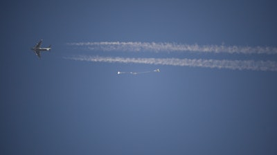 In this photo released by NASA, a replica Orion Spacecraft is dropped from a U.S. Air Force C-17 transport aircraft at 35,000 feet in altitude to a southwestern Arizona desert site to test the craft's ability to cope with a partial parachute failure at the U.S. Army Proving Ground in Yuma, Ariz., Friday, Dec. 15, 2017. The test used two of Orion's three main parachutes to simulate the failure of the third and still sufficiently slowed the spacecraft for a landing. It was the fifth of eight tests to qualify Orion's parachute system for flights with astronauts beginning with Exploration Mission-2.