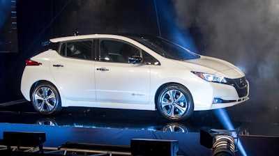 Jose Munoz, the chairman of Nissan North America, presents the first 2018 Nissan Leaf produced at the Japanese automaker's sprawling plant in Smyrna, Tenn., Monday, Dec. 4, 2017.