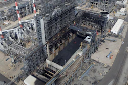 In this Sept. 21, 2017 photo, petroleum coke, the grainy black byproduct of refining Canadian tar sands oil, is visible at the BP Whiting refinery in East Chicago, Ind. The U.S. is the world's largest producer and exporter of 'petcoke,' with the largest share being shipped to India in recent years. The high-carbon, high-sulfur fuel is dirtier than coal, and has been burned unregulated in Indian factories and power plants, contributing to that nation's already-high air pollution levels.