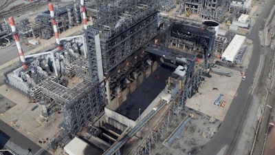 In this Sept. 21, 2017 photo, petroleum coke, the grainy black byproduct of refining Canadian tar sands oil, is visible at the BP Whiting refinery in East Chicago, Ind. The U.S. is the world's largest producer and exporter of 'petcoke,' with the largest share being shipped to India in recent years. The high-carbon, high-sulfur fuel is dirtier than coal, and has been burned unregulated in Indian factories and power plants, contributing to that nation's already-high air pollution levels.