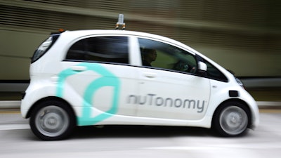 In this Wednesday, Aug. 24, 2016, file photo a nuTonomy autonomous vehicle is driven during its test drive in Singapore. Lyft and its Boston-based partner nuTonomy, which builds autonomous software, announced Wednesday, Dec. 6, 2017, that a pilot project has begun sending self-driving cars to pick up commuters in Boston's Seaport District, a burgeoning technology hub.