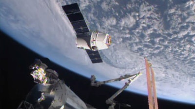 In this April 17, 2015, file image from NASA-TV, the SpaceX Dragon 6 resupply capsule nears the International Space Station. The capsule will be making a return trip to the space station when it is launched on a recycled rocket for NASA on Tuesday, Dec. 12, 2017.