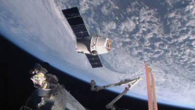 In this April 17, 2015, file image from NASA-TV, the SpaceX Dragon 6 resupply capsule nears the International Space Station. The capsule will be making a return trip to the space station when it is launched on a recycled rocket for NASA on Tuesday, Dec. 12, 2017.