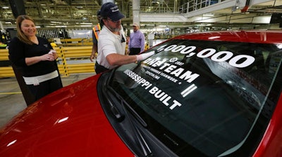 Brad Collins makes on last inspection and wipes down the car before a ceremony to celebrate the 1,000,000th Toyota Corolla to roll off the Toyota Motor Manufacturing Mississippi Plant, Tuesday, Dec. 12, 2017, in Blue Springs, Miss.