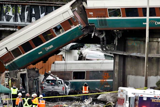 Cars from an Amtrak train lay spilled onto Interstate 5 below alongside smashed vehicles as some train cars remain on the tracks above Monday, Dec. 18, 2017, in DuPont, Wash. The Amtrak train making the first-ever run along a faster new route hurtled off the overpass Monday near Tacoma and spilled some of its cars onto the highway below, killing some people, authorities said. Seventy-eight passengers and five crew members were aboard when the train moving at more than 80 mph derailed about 40 miles south of Seattle before 8 a.m., Amtrak said.