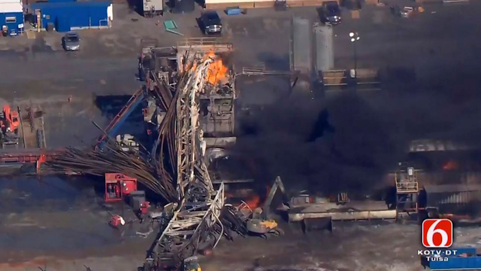 In this photo provided from a frame grab from Tulsa's KOTV/NewsOn6.com, fires burn at an eastern Oklahoma drilling rig near Quinton, Okla., Monday Jan. 22, 2018. Five people are missing after a fiery explosion ripped through a drilling rig, sending plumes of black smoke into the air and leaving a derrick crumpled on the ground, emergency officials said.