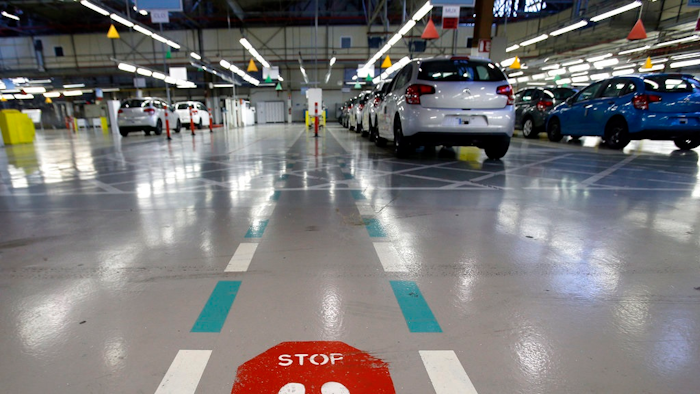 This Jan.28 2013 file photo, shows the French car manufacturer PSA Peugeot Citroen assembly line in Aulnay-sous-Bois, north of Paris. The maker of Peugeot and Citroen cars hopes to lay off 1,300 people this year and hire another 1,300 under new labor rules championed by President Emmanuel Macron to give companies more flexibility to hire and fire. PSA is among the first big companies to apply the new rules, which came into effect this month.