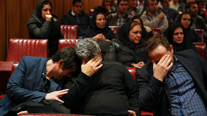 Friends and colleagues of the deceased Iranian seafarers aboard a tanker that sank off the coast of China weep at the headquarters of National Iranian Tanker Company, in Tehran, Iran, Sunday, Jan. 14, 2018. The burning Iranian tanker listing for days off the coast of China after a collision with another vessel sank Sunday, with an Iranian official saying there was 'no hope' of survival for the 29 missing sailors onboard.