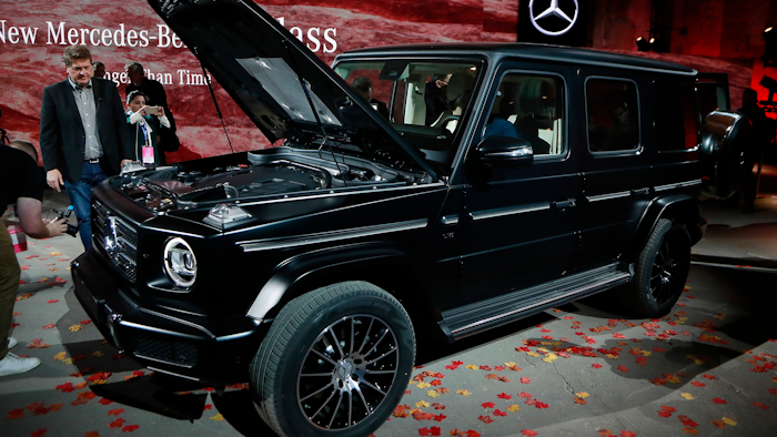 Members of the media look over the Mercedes-Benz G-Class during the North American International Auto Show, Sunday, Jan. 14, 2018, in Detroit.