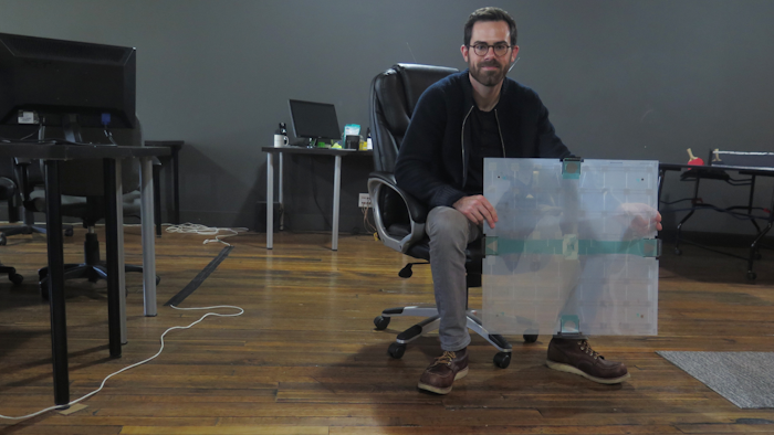 In this photo taken Dec. 5, 2017, Scanalytics co-founder and CEO Joe Scanlin holds a smart floor sensor his company creates that track people's movements in Milwaukee. The sensors are among the tools retailers are using to gain insights on consumer habits.