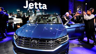 Following a press conference, members of the media photograph the 2019 Volkswagen Jetta at the North American International Auto Show Sunday, Jan. 14, 2018, in Detroit.