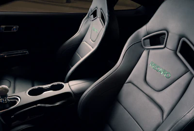 The leather-trimmed interior features unique green accent stitching on the dashboard, door panels, center console and seats.